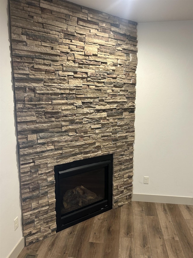 interior details featuring hardwood / wood-style floors and a fireplace