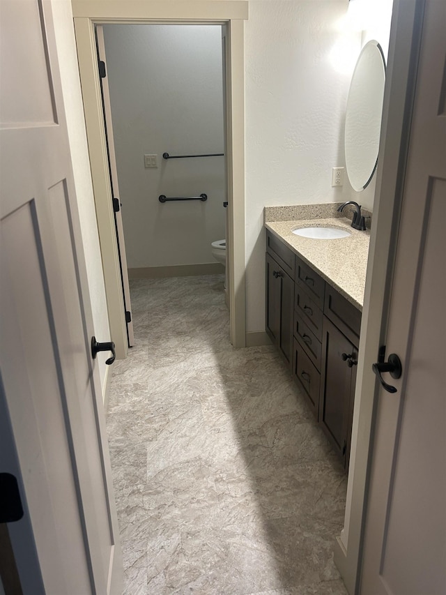 bathroom featuring vanity and toilet