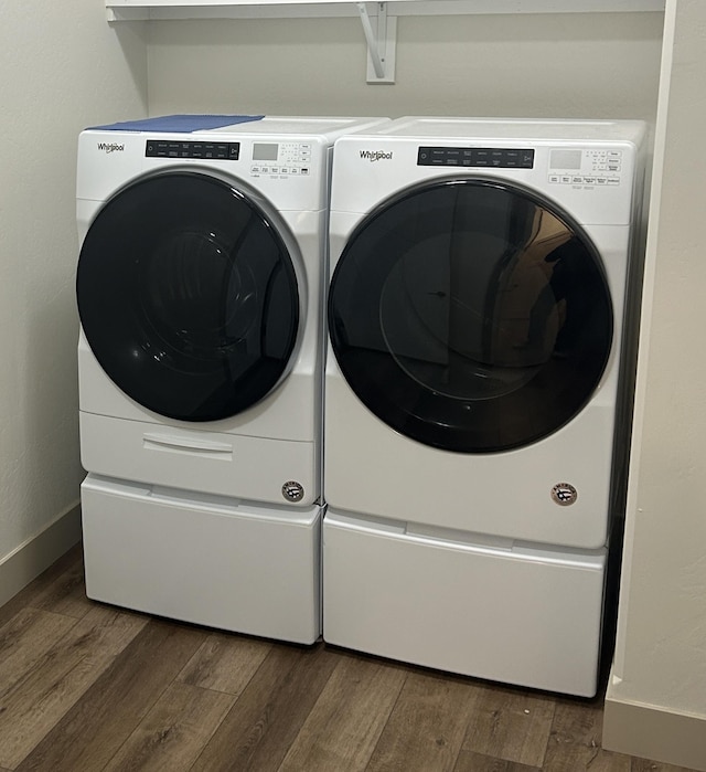 laundry area with washing machine and dryer and dark hardwood / wood-style floors