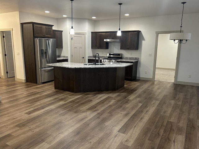 kitchen featuring dark brown cabinetry, stainless steel appliances, hanging light fixtures, and sink