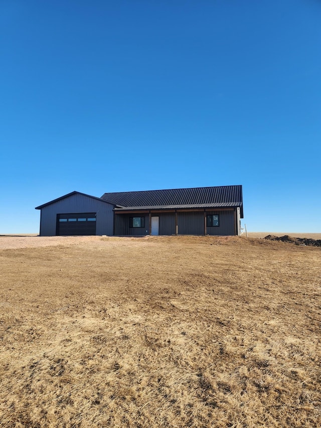 view of front of house featuring a garage and an outdoor structure