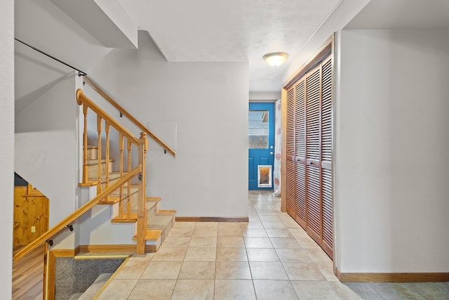 hall featuring light tile patterned floors