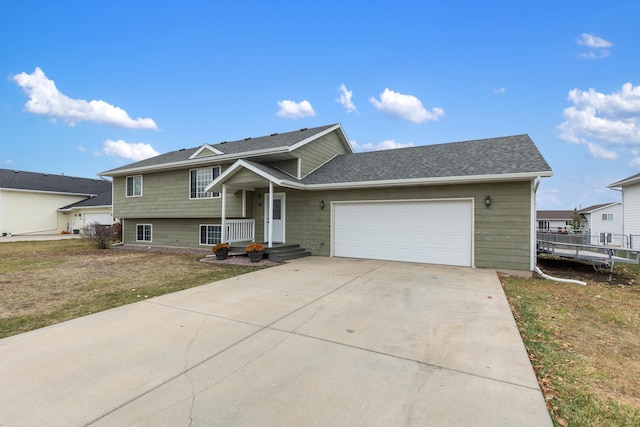 view of front of property with a front lawn and a garage