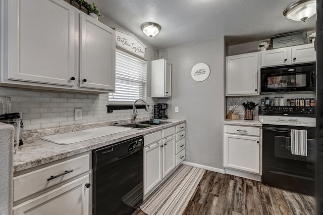 kitchen with a textured ceiling, sink, black appliances, white cabinets, and dark hardwood / wood-style floors