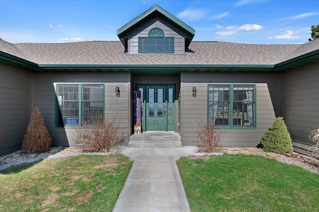 doorway to property with a lawn