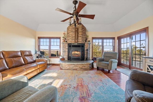 living room featuring ceiling fan, plenty of natural light, wood-type flooring, and vaulted ceiling