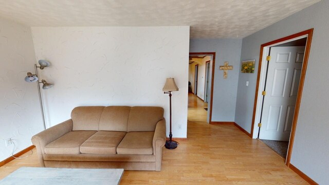 171 N Newton Ave, Hill City, SD 57745 - unfurnished living room featuring a textured ceiling and light hardwood / wood-style floors
