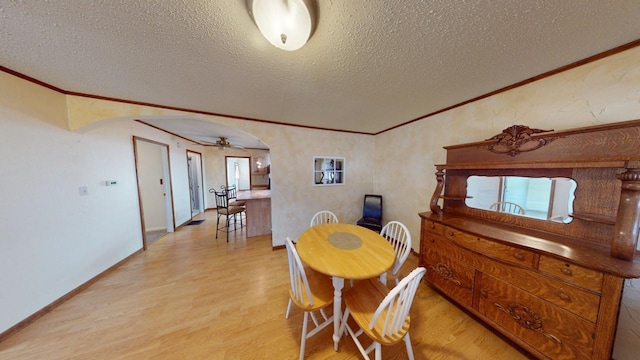 171 N Newton Ave, Hill City, SD 57745 - dining space with light wood-type flooring, a textured ceiling, ceiling fan, and ornamental molding