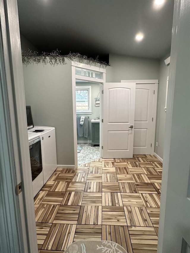 clothes washing area featuring independent washer and dryer and light parquet floors