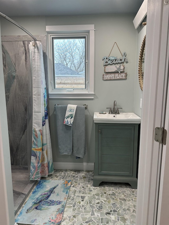 bathroom featuring curtained shower and vanity