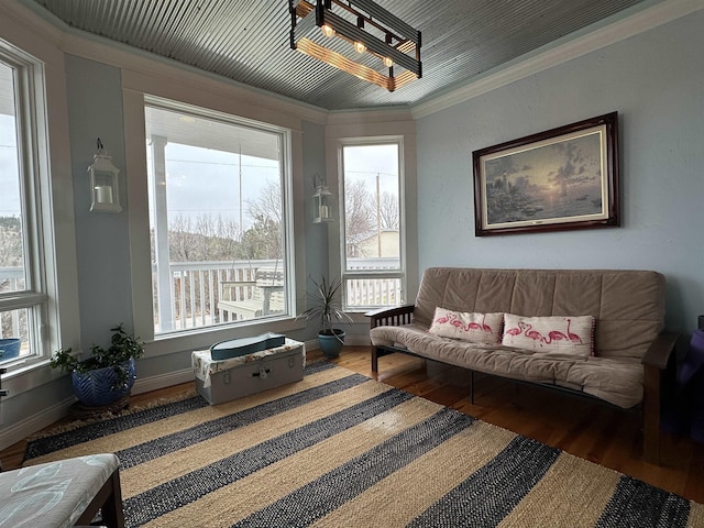 living room featuring plenty of natural light, dark hardwood / wood-style floors, and crown molding