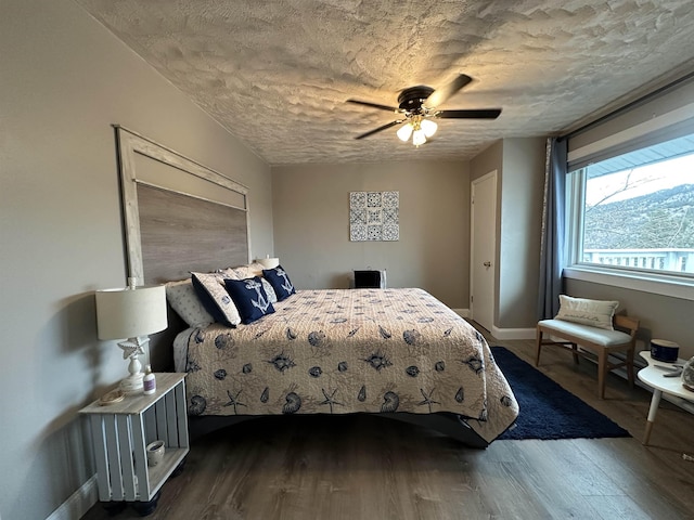 bedroom with ceiling fan and dark hardwood / wood-style floors