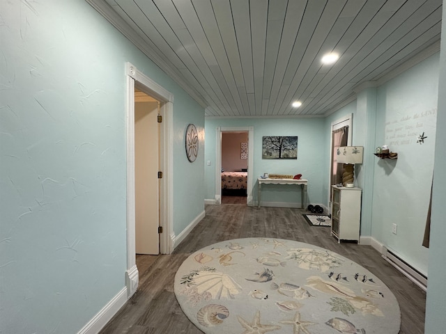 corridor featuring hardwood / wood-style floors, baseboard heating, and wood ceiling