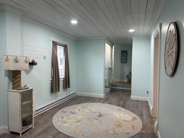 hallway featuring ornamental molding, wood ceiling, dark wood-type flooring, and a baseboard heating unit