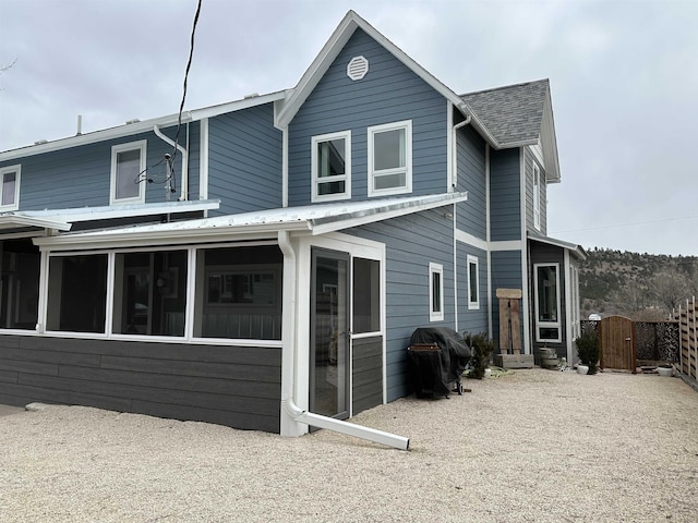 back of property with a sunroom