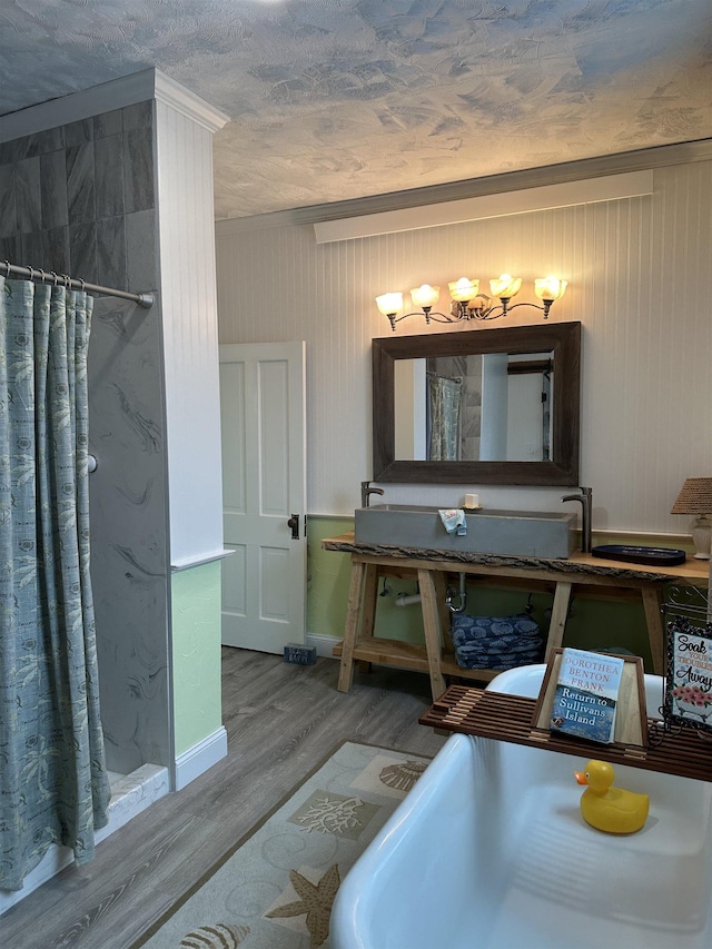 bathroom featuring crown molding, wood-type flooring, and a shower with shower curtain