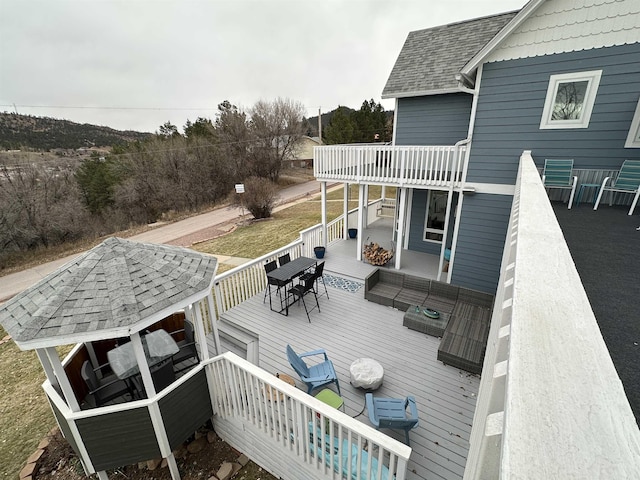 wooden deck featuring a gazebo and an outdoor living space