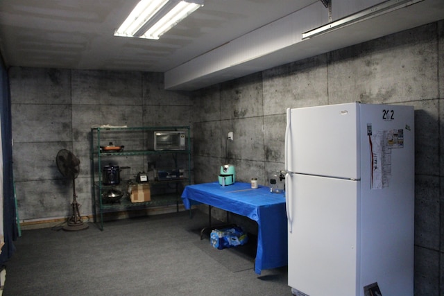 basement with white refrigerator