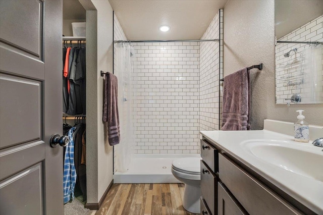 bathroom with vanity, toilet, a shower with shower curtain, and hardwood / wood-style flooring