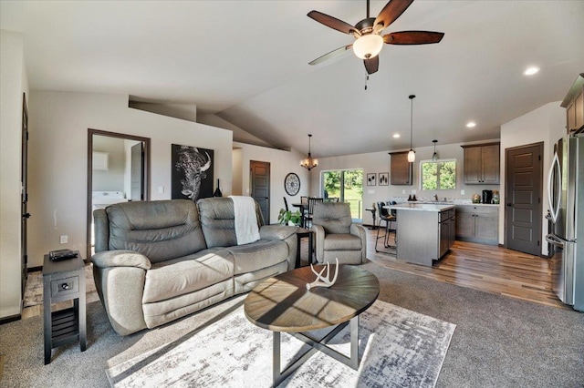 living room with washer / clothes dryer, ceiling fan, lofted ceiling, and dark colored carpet