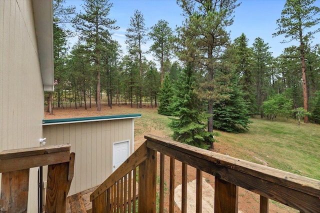 wooden terrace featuring a yard