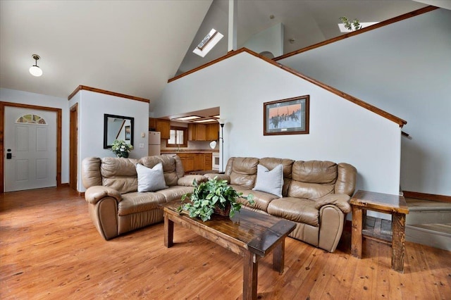 living room with light hardwood / wood-style floors and high vaulted ceiling