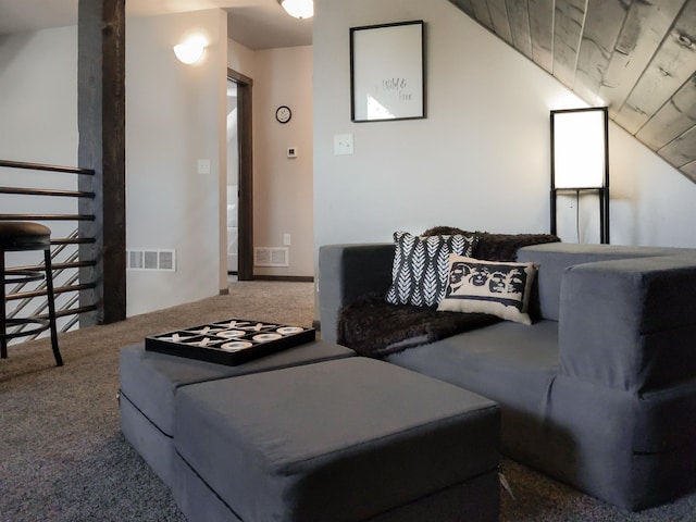 carpeted living room featuring lofted ceiling