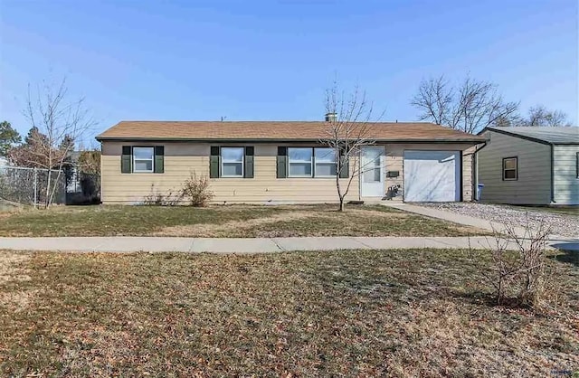 single story home featuring a front lawn and a garage