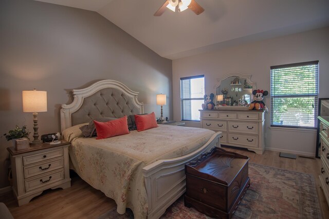 bedroom with hardwood / wood-style flooring, ceiling fan, and lofted ceiling