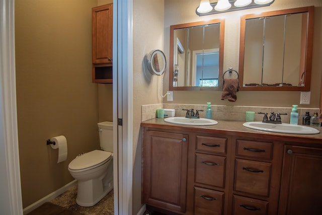 bathroom with decorative backsplash, vanity, and toilet