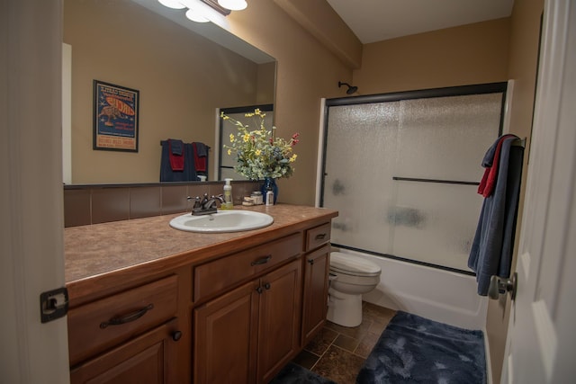 full bathroom with shower / bath combination with glass door, vanity, and toilet