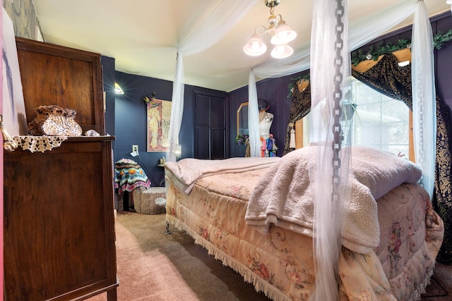 bedroom with a notable chandelier and light carpet