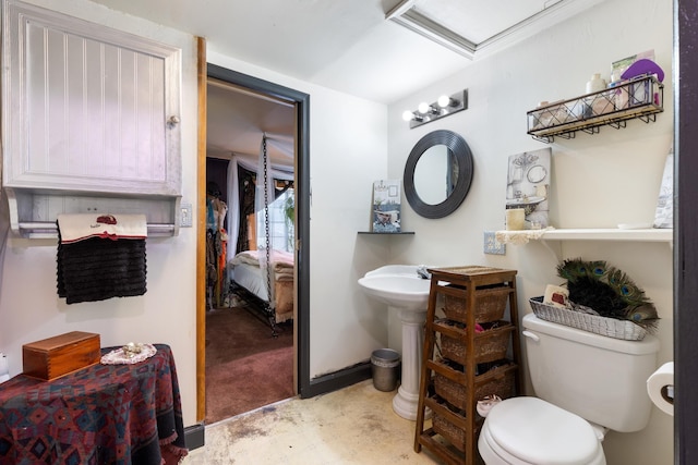 bathroom featuring concrete floors and toilet