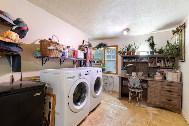 clothes washing area with a textured ceiling and washing machine and dryer