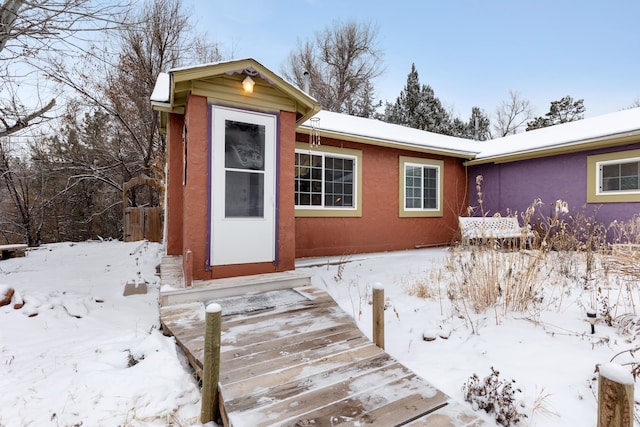 view of snow covered property entrance