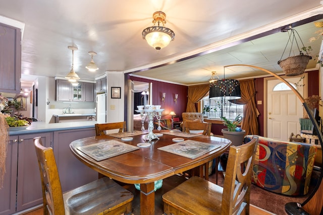 dining space with crown molding and wooden walls