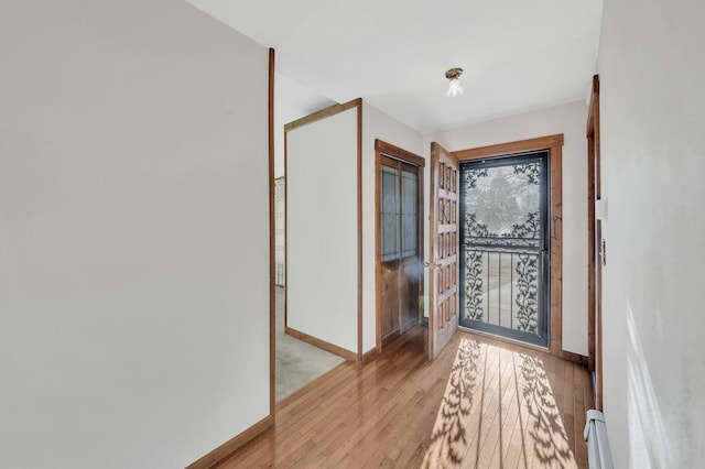 foyer featuring light wood-type flooring and a baseboard radiator