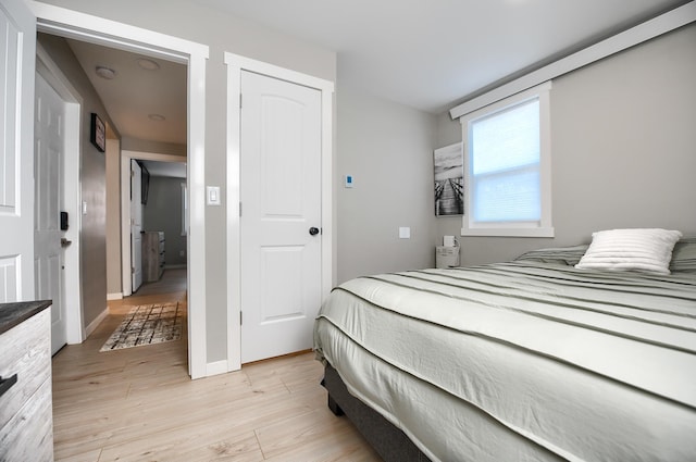 bedroom featuring light hardwood / wood-style flooring and a closet