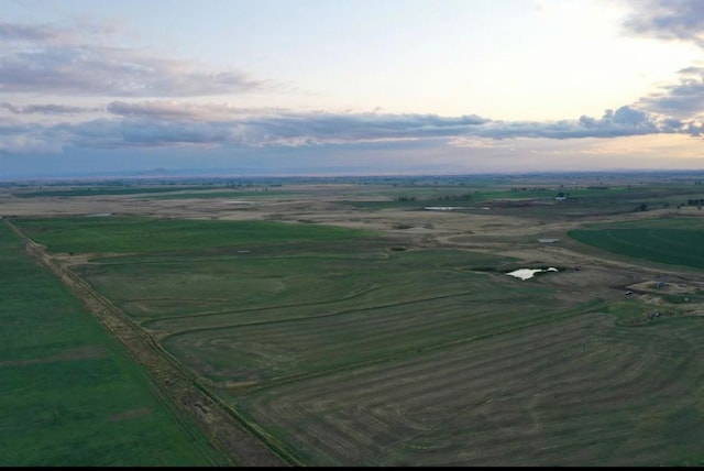 aerial view at dusk featuring a rural view