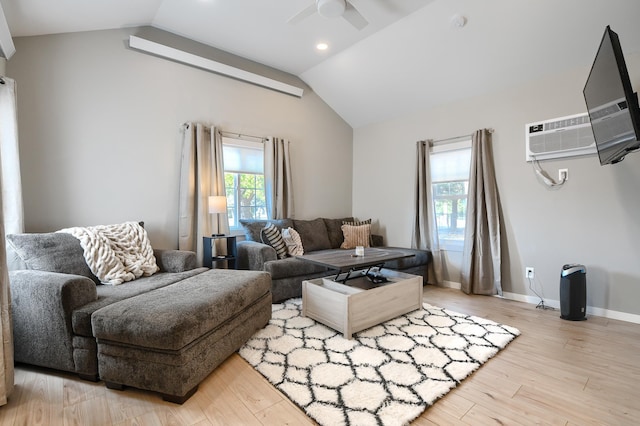 living room featuring a wall mounted AC, ceiling fan, lofted ceiling, and light wood-type flooring