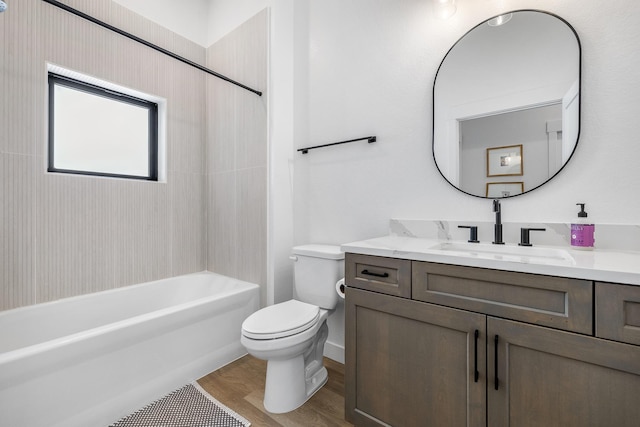 full bathroom featuring hardwood / wood-style flooring, shower / washtub combination, vanity, and toilet