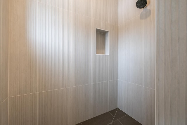 interior details featuring tiled shower