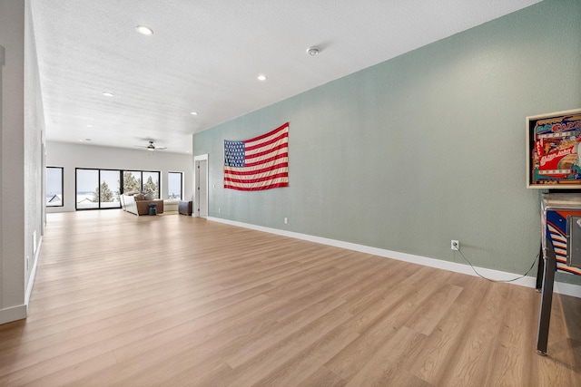 living room with ceiling fan and light hardwood / wood-style floors