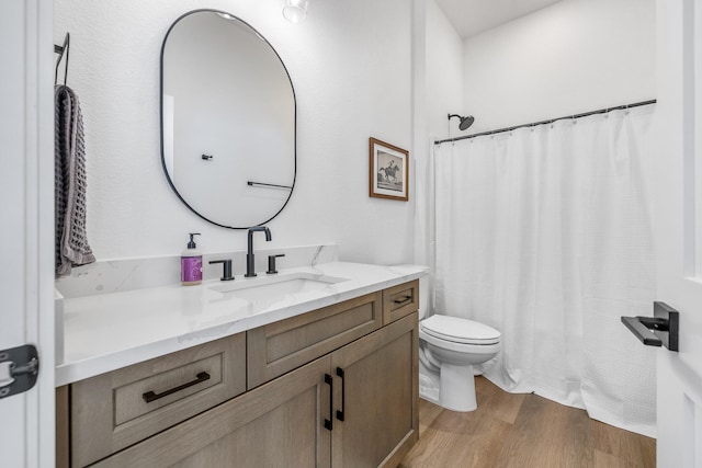 bathroom with vanity, hardwood / wood-style floors, and toilet