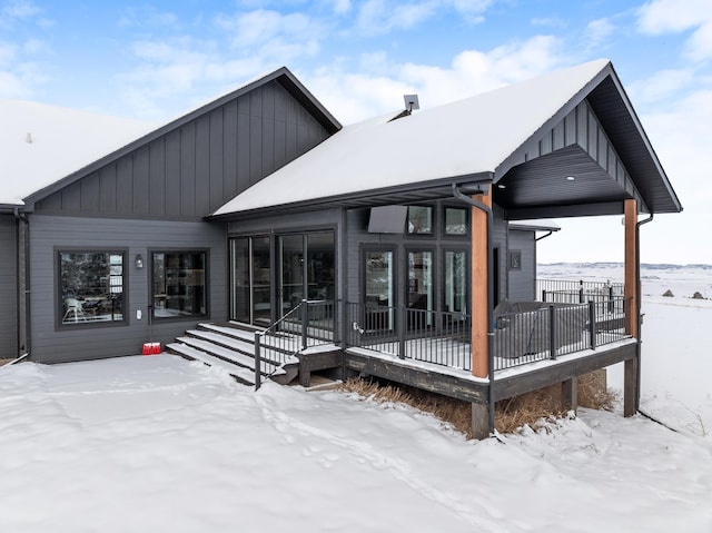 view of snow covered rear of property