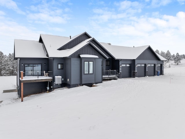 snow covered house with a garage