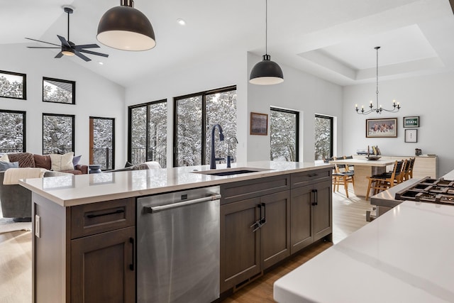 kitchen with pendant lighting, dishwasher, a kitchen island with sink, sink, and a wealth of natural light