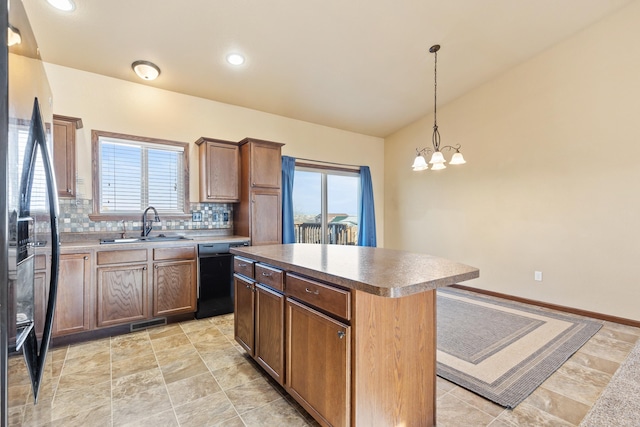 kitchen featuring backsplash, black appliances, a chandelier, a kitchen island, and hanging light fixtures