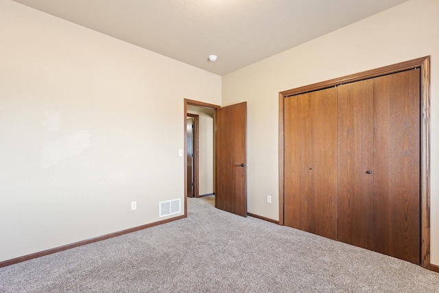 unfurnished bedroom with carpet and a closet