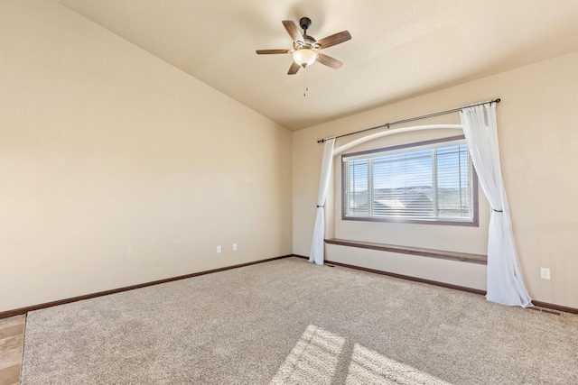 carpeted empty room featuring vaulted ceiling and ceiling fan